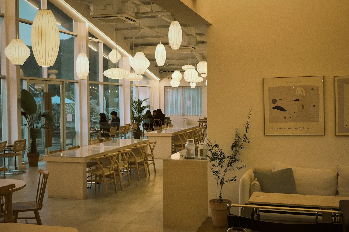 Interior of Ember & Oak Coffee with tables, pastries, and espresso bar.
